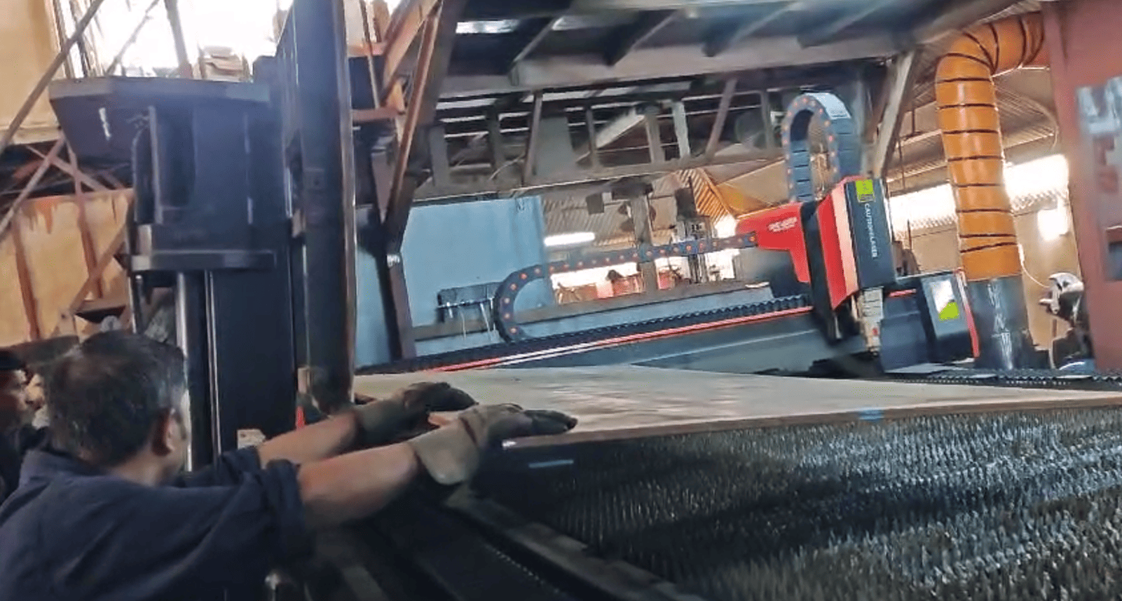 Worker operating laser cutting machine